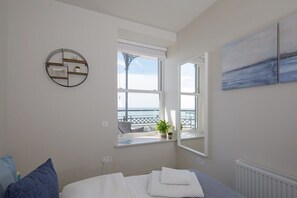 The bedroom at the front of the apartment has sea-views