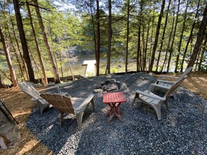 Tranquil fire pit with lake view. Ample complementary firewood on site to enjoy.