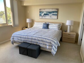 Master bedroom with king bed, walk in closet and attached bathroom.