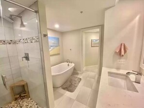 Master bedroom bathroom with shower and tub.