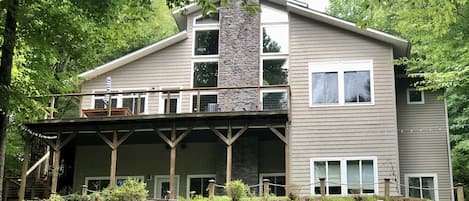 Back of home overflowing with views of lake and relaxing area's on both levels