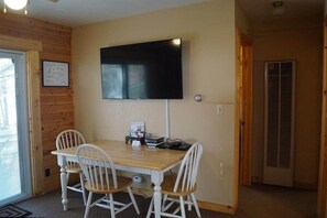 Living Room/Dining Room has a nice size table and a large TV.