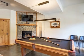 Downstairs Pool Table Entertainment Room. With gas fireplace, TV and 3rd guest room, full bathroom and laundry room. All above ground, access to hot tub and driveway