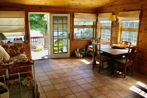 Sun room with table for dining, games, and relaxing!