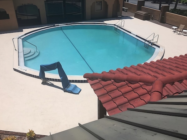 Swimming pool, poolside loungers and picnic tables