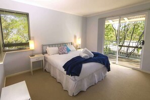 Master bedroom with queen bed and access to the front deck/entry