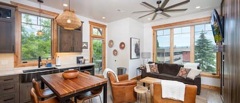 The open concept kitchen and living area are a beautifully decorated, cozy space.