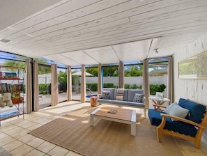 An indoor sunroom area with an easy access to the pool.
