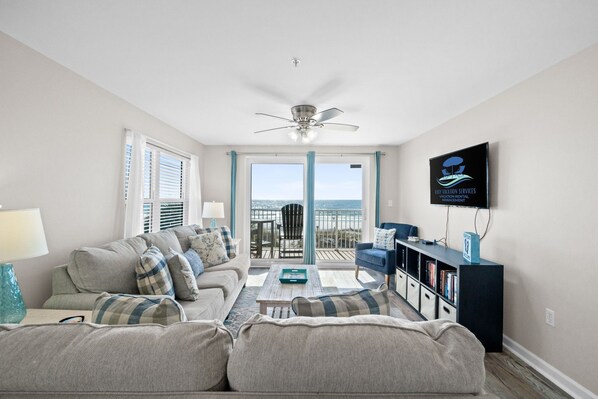 Cozy living room with natural light and beautiful ocean views just outside