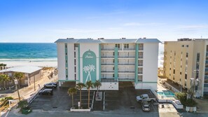 Exterior view of the beachside condominium building, highlighting its proximity to the ocean.