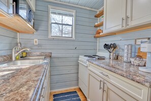 Full kitchen with refrigerator, oven, stove, coffee maker