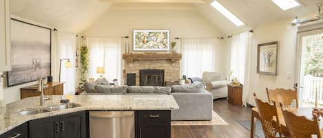 Main living area of home with open concept kitchen/dining/living room.