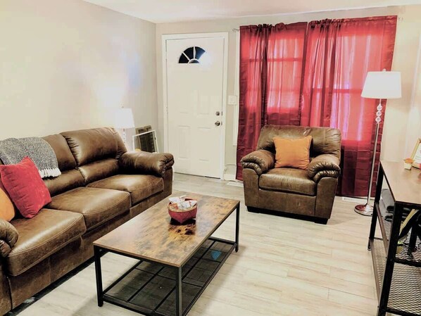 The living room is a cozy and stylish space, featuring comfortable seating, elegant decor, and a welcoming ambiance—perfect for relaxing and unwinding.