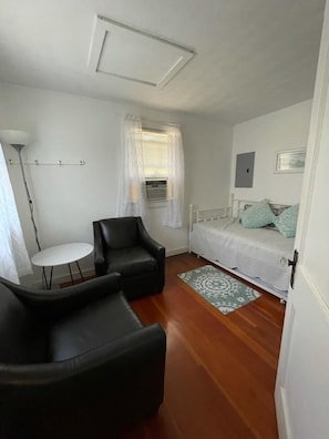 2nd bedroom: two leather chairs, side table.  Sit down for a book or watch TV