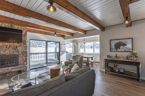 Front room with TV, wood burning fireplace, deck access. .