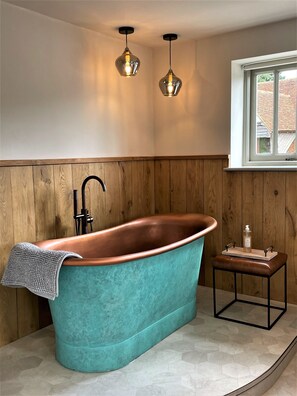 Decadent Verdigris copper bath with organic toiletries with essential oils