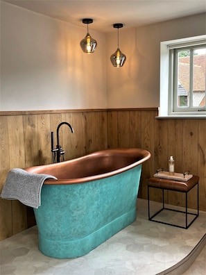 Decadent Verdigris copper bath with organic toiletries with essential oils