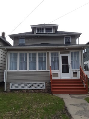 Entry into a welcoming enclosed Front Porch.