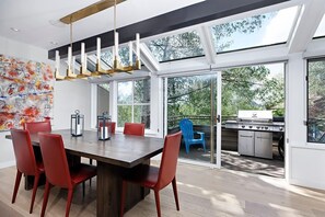 Dining area opening to outdoor deck with views and BBQ Grill