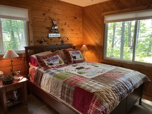 The lakeside Master bedroom - windows opening to the lapping waves and loons