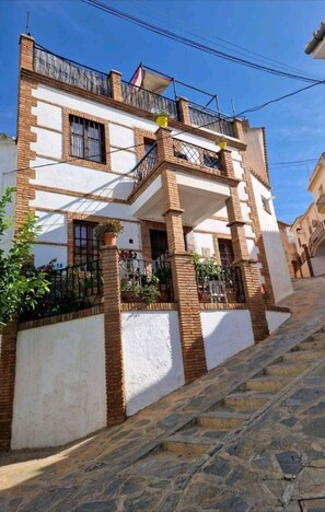 Set at an elevated position with external patios & terraces at 4 levels