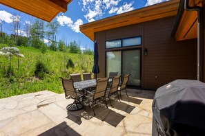 Private patio offering a fireplace, seating and a gas grill