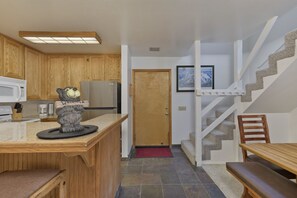 Kitchen, front door, and dining