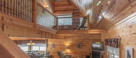 Beautiful craftsmanship creates a striking interior for this beautiful cabin nestled in the trees among Dahlonega's surrounding hillsides