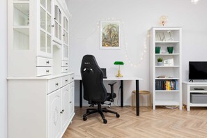 A compact home office area with a desk, ergonomic chair, and minimalist decor, ideal for remote work.