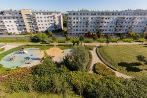 A view of the lush, green outdoor surroundings with walking paths and recreational areas near the apartment complex.