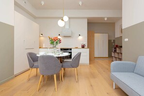 A cozy living and dining area with soft furnishings and a welcoming ambiance.
