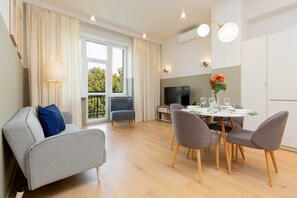 A cozy living and dining area with soft furnishings and a welcoming ambiance.
