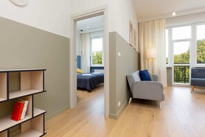 A hallway leading to the living space, showcasing a bright and airy design.
