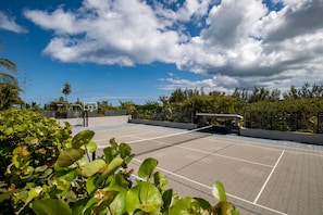 Tennis court also lined for pickleball and with a basketball net and shuffleboard court.