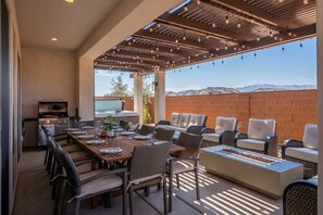 Enjoy evenings on this well-equipped patio: fire pit, hot tub, lounge seating, patio lights, BBQ and more