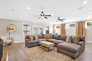 Living Room | Breathe Easy Rentals - Spacious Living Room with a large comfy sofa for anytime of the day lounging.