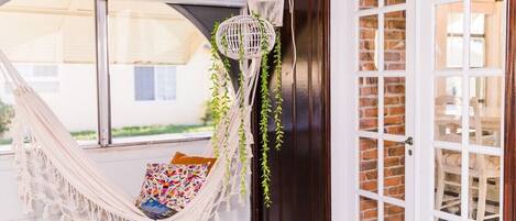 Relax in our cozy corner with a comfy hammock, perfect for unwinding with a book or simply enjoying the gentle Florida breeze. This tranquil spot, nestled by bright windows and warm accents, offers a serene retreat from your everyday hustle.





