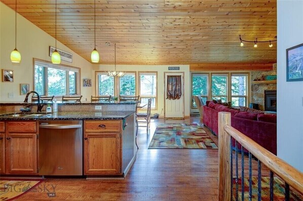 Large open concept living space with kitchen, dining and living room upstairs.