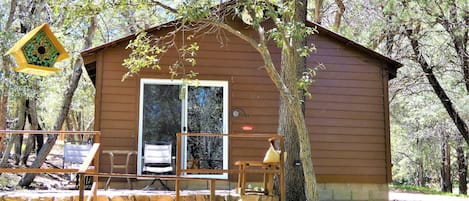 Patio area with bird feeders, seating and gas grill.  Perfect place to relax!