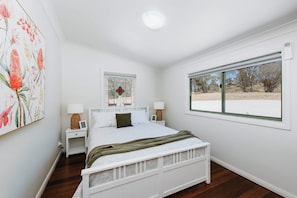 The Banksia Queen bedroom is on the verandah, with bush land to view.