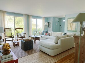 Living room with sliding doors, nature views of the wetlands of the Berkshires' Great Barrrington