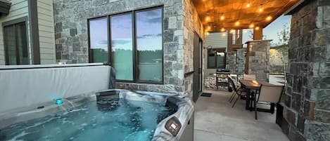 Private hot tub- enjoy the beautiful ambiance of the patio with fire pit table