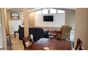 Dining and Living areas in Cottage L - Sofa is a Full Size pull out bed