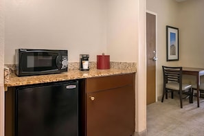 This unit comes with a mini-fridge, coffee maker, and a microwave!