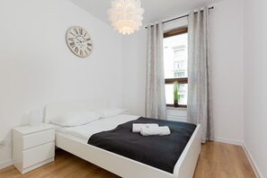 A cozy bedroom with a double bed, soft bedding, and neutral tones for a calm and relaxing atmosphere.