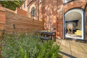 7 Swan Court, Fakenham: The upper patio with arch door leading to sitting room