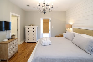 - Drift into restful sleep in this cozy king suite, where soft linens and beachy tones create instant calm - Chandelier overhead & charming white shiplap wall add a touch of Southern elegance - Wake up refreshed with natural light & serene simplicity