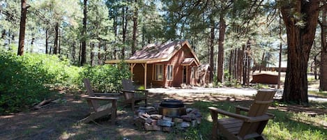 Wood burning fire pit adjacent to the cabin