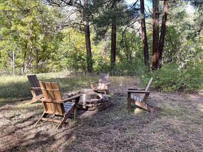 Wood burning fire pit adjacent to the cabin