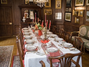 The Dining Room. Wood panelled and hung with landscape paintings.
